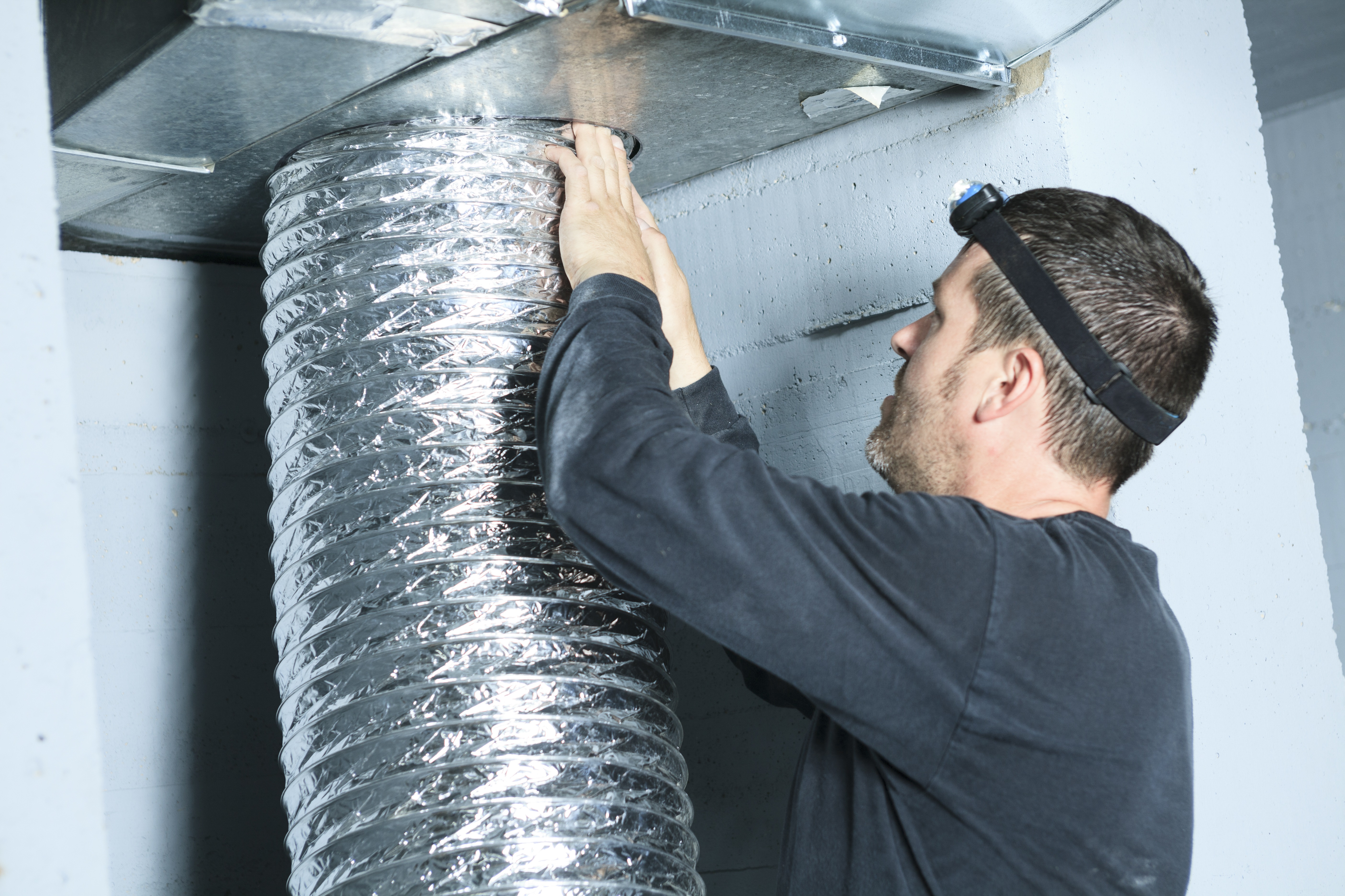 Man Checking The Air Ducts