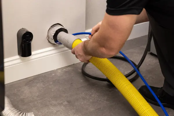 tech vacuuming dryer vent 1